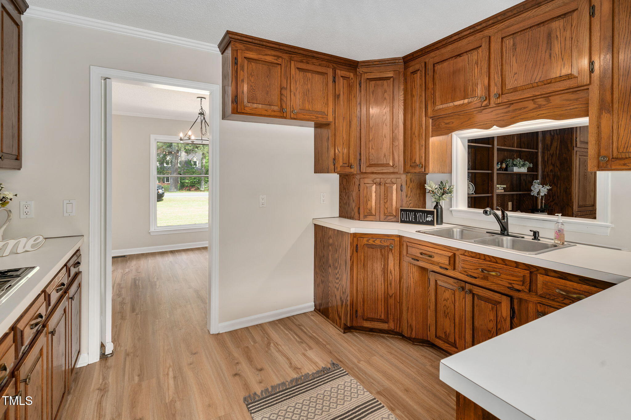 603 Warren Road Erwin, NC 28339 - Photo 14 of 38 a kitchen with stainless steel appliances granite countertop a sink and wooden cabinets with wooden floors