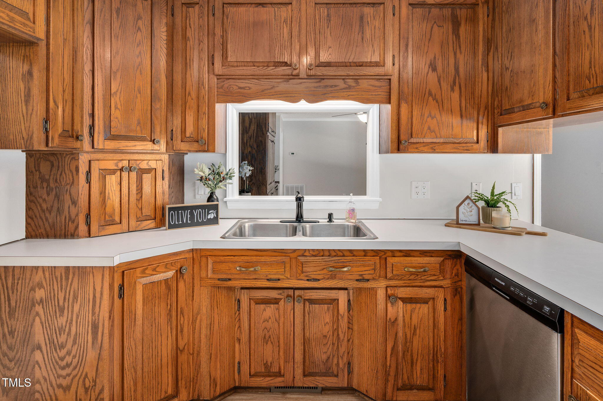 603 Warren Road Erwin, NC 28339 - Photo 15 of 38 a kitchen with stainless steel appliances wooden cabinets a sink and a microwave