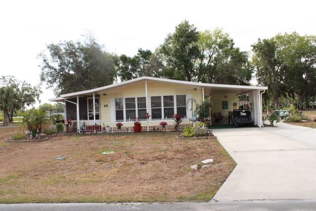 a view of a house with a large window and a yard