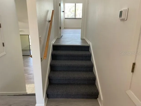 a view of entryway and hall with wooden floor