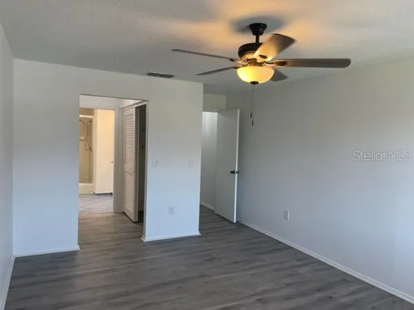 a view of a chandelier fan and wooden floor
