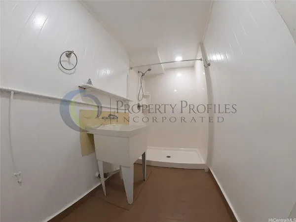 a bathroom with a sink a light fixture and a mirror