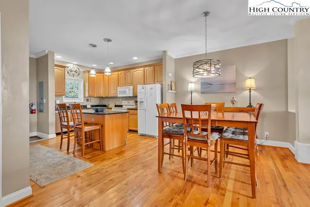 a view of a dining room with furniture wooden floor and a chandelier