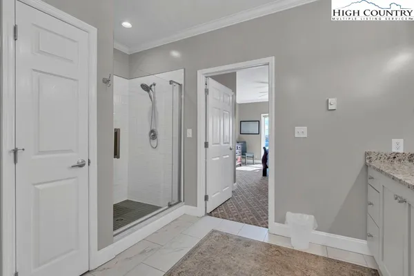a bathroom with a granite countertop sink a toilet and a mirror