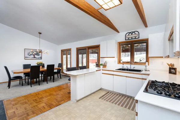 a kitchen with stainless steel appliances a sink stove and cabinets
