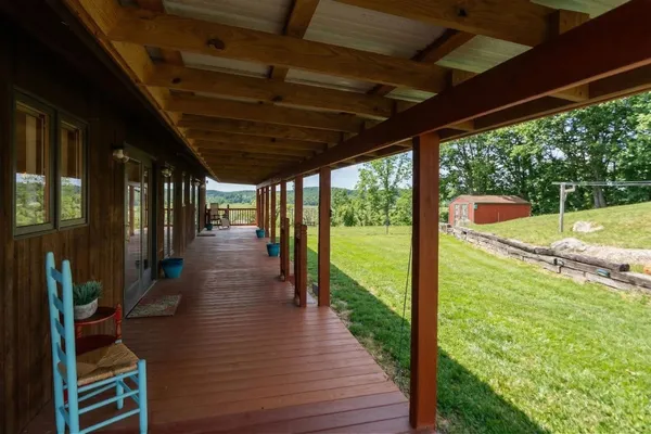 a view of a house with pool and a yard