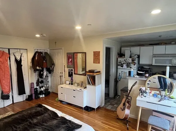 a view of a kitchen with refrigerator and workspace