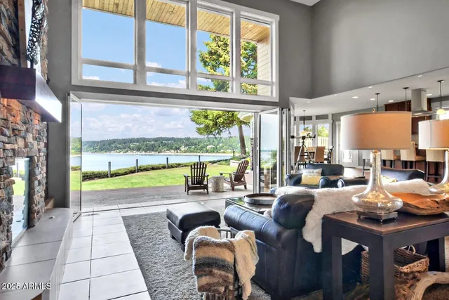 a bedroom with furniture and large windows