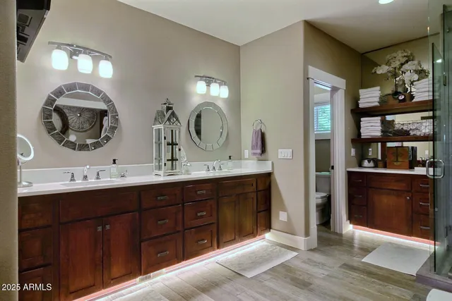 a bathroom with a double vanity sink and a mirror