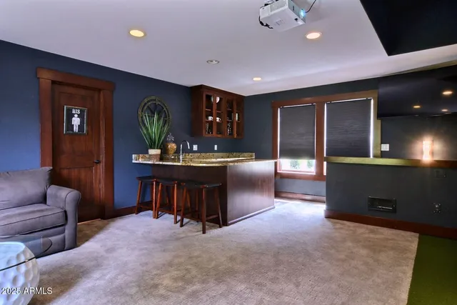 a living room with furniture and a dining table