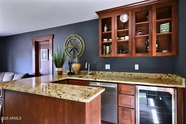 a kitchen with a granite countertop sink and a granite counter top
