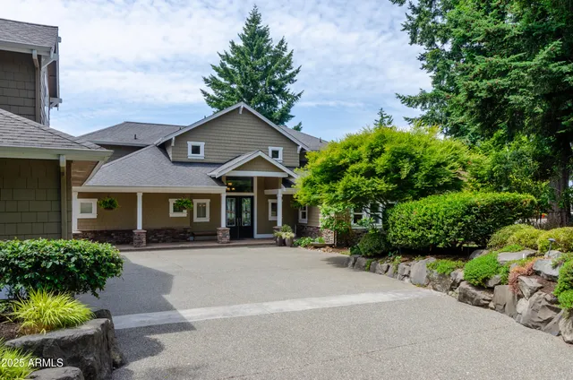 a front view of a house with a garden
