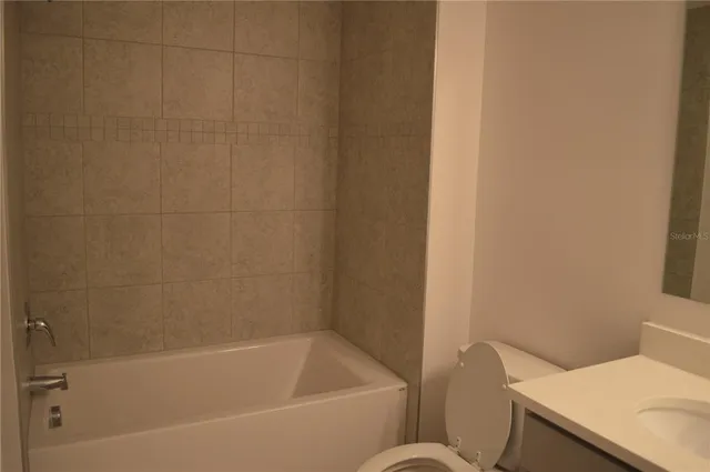 a bathroom with a bathtub and toilet