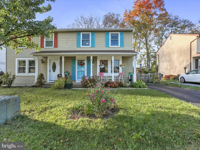 a view of a brick house with a yard patio and a fountain