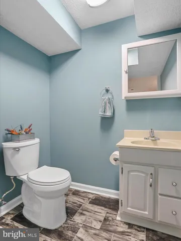 a bathroom with a sink toilet and mirror