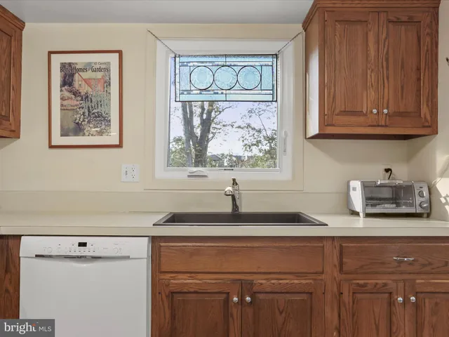 a kitchen with granite countertop a sink and a window