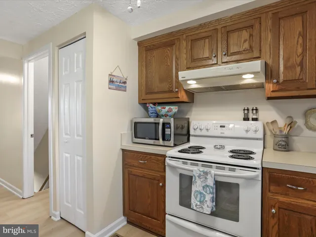 a kitchen with stainless steel appliances granite countertop a stove and a refrigerator