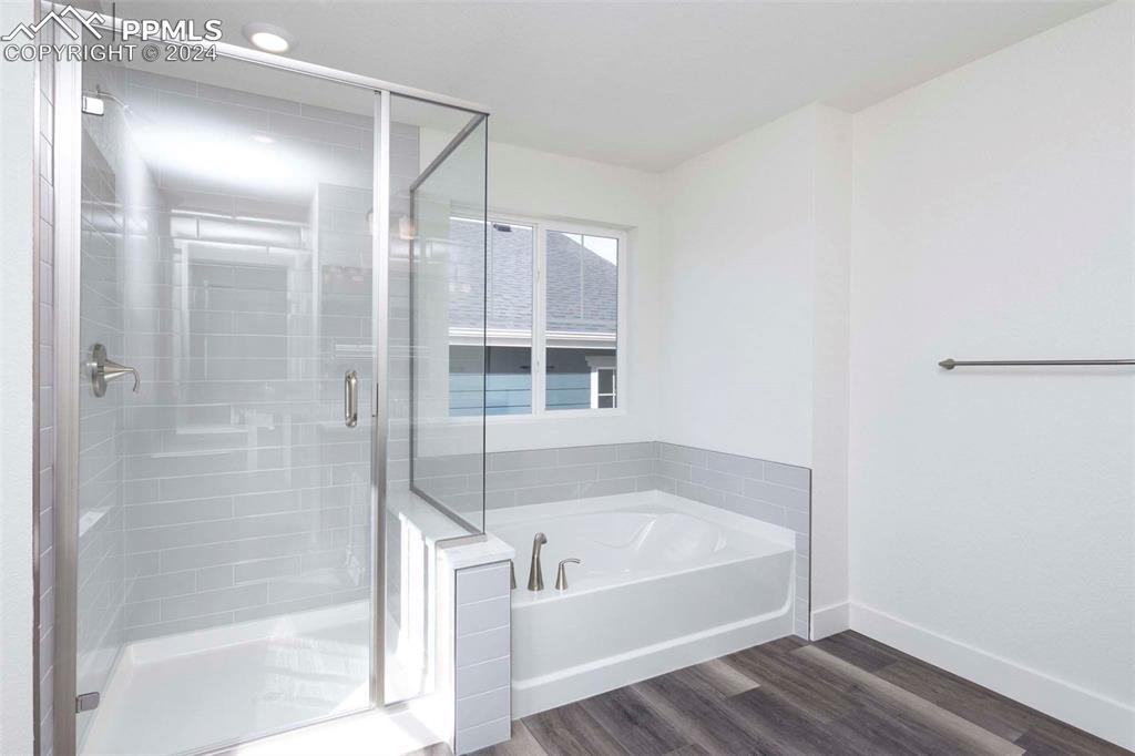2058 Peachleaf Loop Castle Rock, CO 80108 - Photo 19 of 27 a white bath tub sitting next to a shower