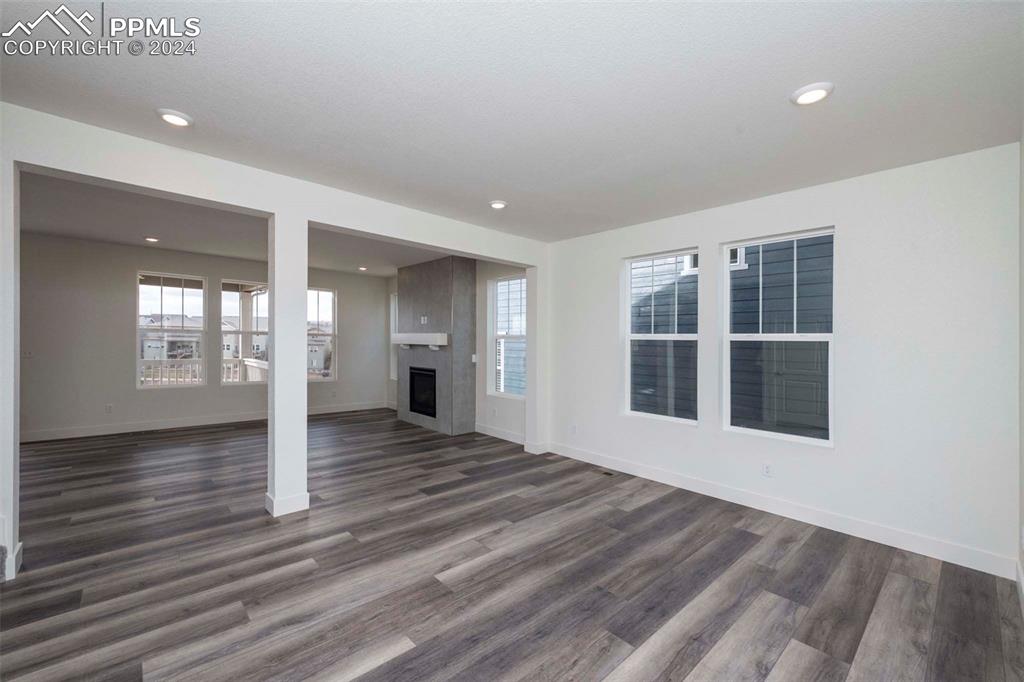 2058 Peachleaf Loop Castle Rock, CO 80108 - Photo 2 of 27 a view of an empty room with wooden floor and a window