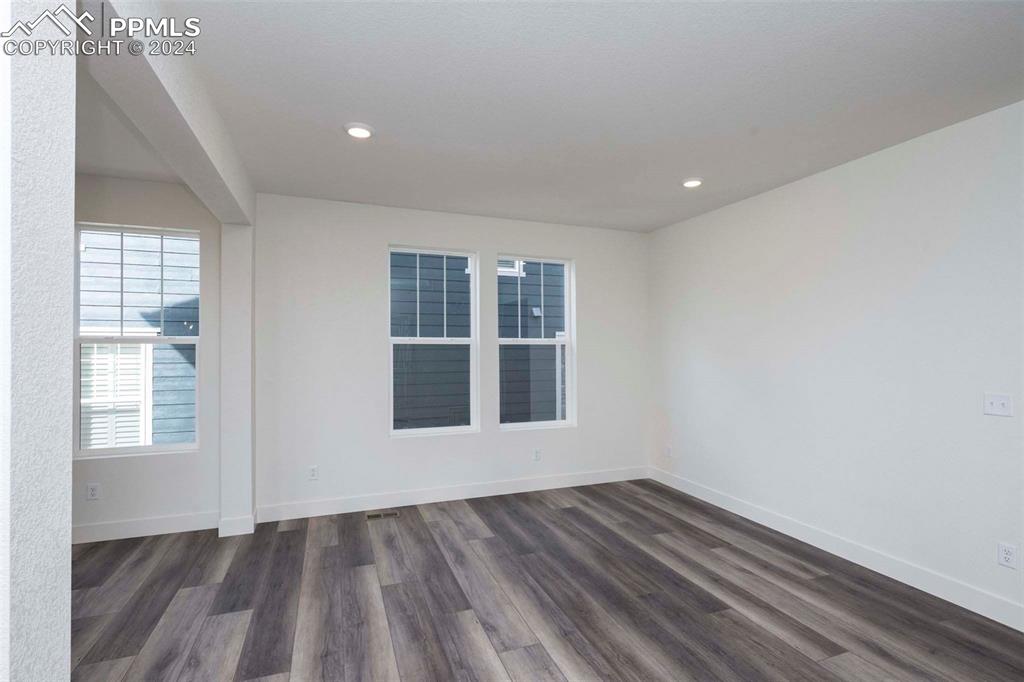 2058 Peachleaf Loop Castle Rock, CO 80108 - Photo 3 of 27 an empty room with wooden floor and windows