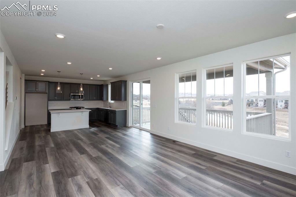 2058 Peachleaf Loop Castle Rock, CO 80108 - Photo 5 of 27 a view of kitchen with wooden floor and windows