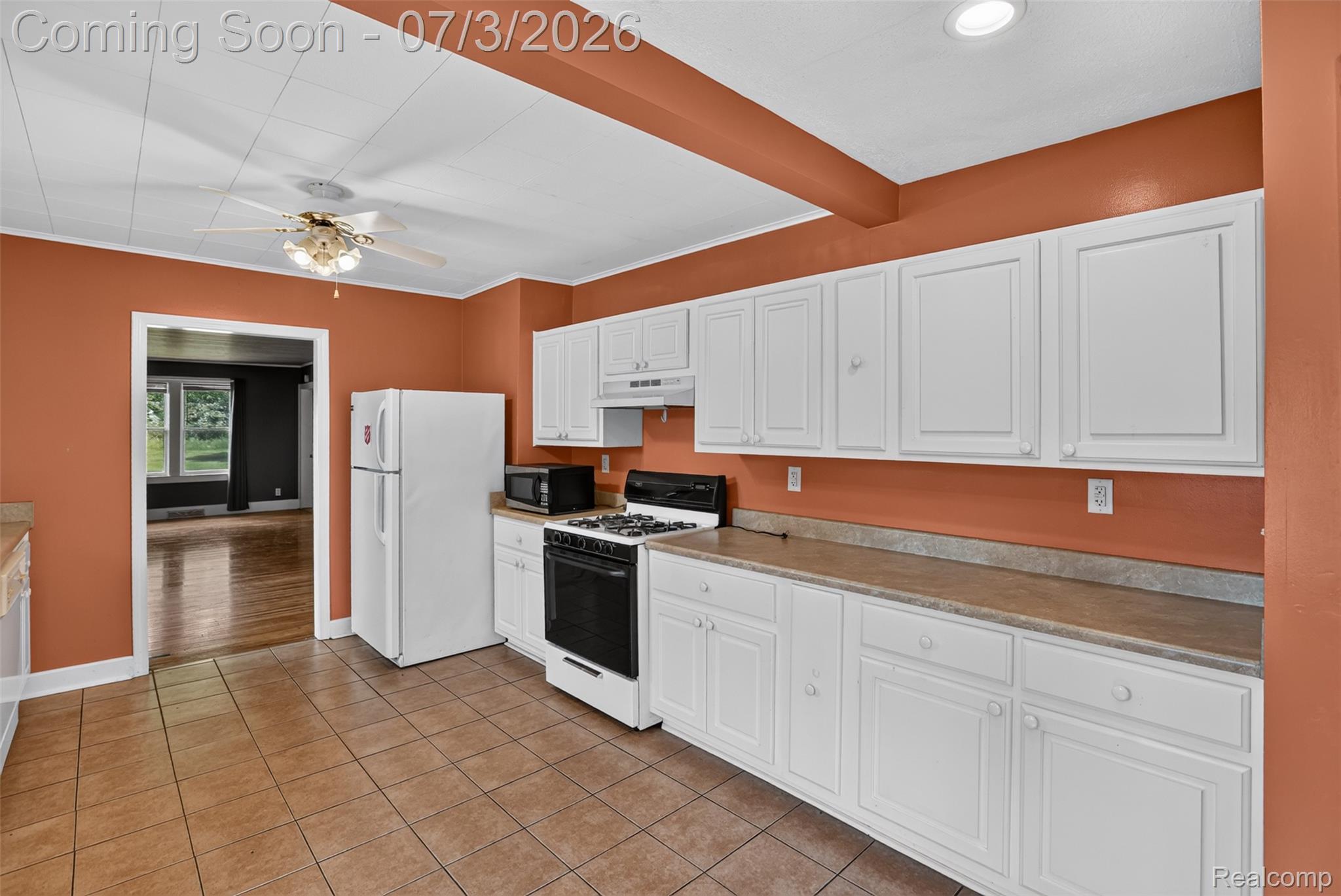 4322 Baker Road Bridgeport, MI 48722 - Photo 5 of 29 Kitchen featuring white cabinetry, tile flooring, and a gas range