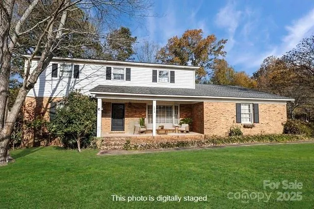 a front view of house with yard and green space
