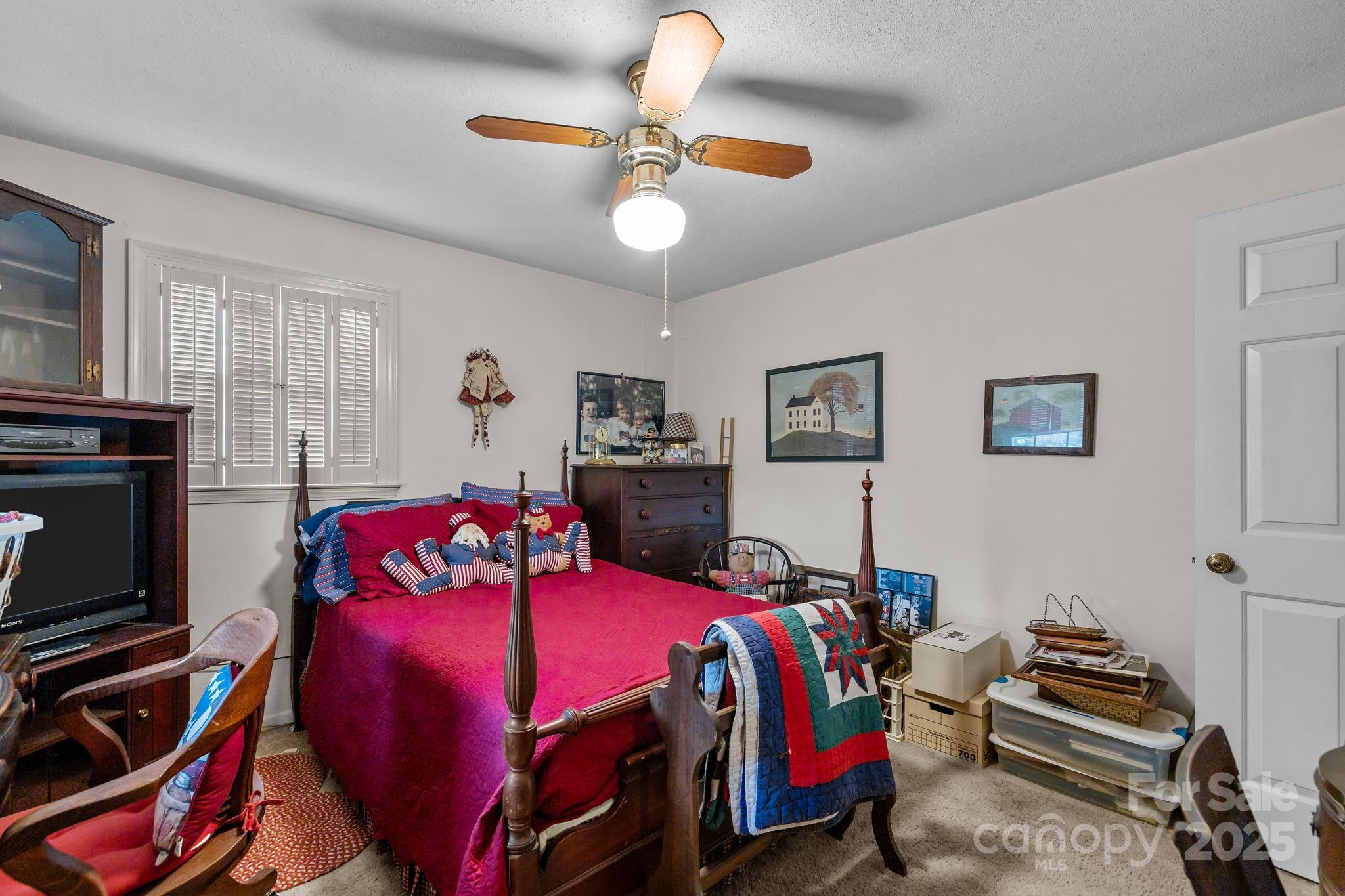 1214 Hawthorne Road Lancaster, SC 29720 - Photo 18 of 35 a bedroom with a bed and a chandelier