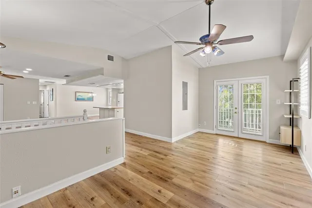 a kitchen with stainless steel appliances granite countertop a sink and cabinets with wooden floor