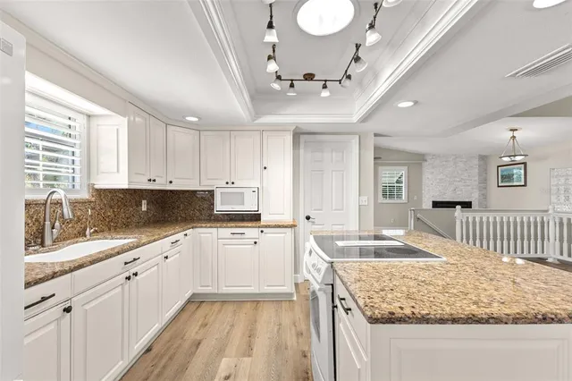a view of empty room with wooden floor and window