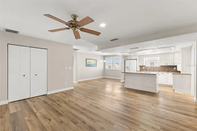 a view of a kitchen with a sink and wooden floor