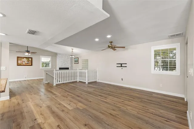a view of an empty room with a window and a fireplace