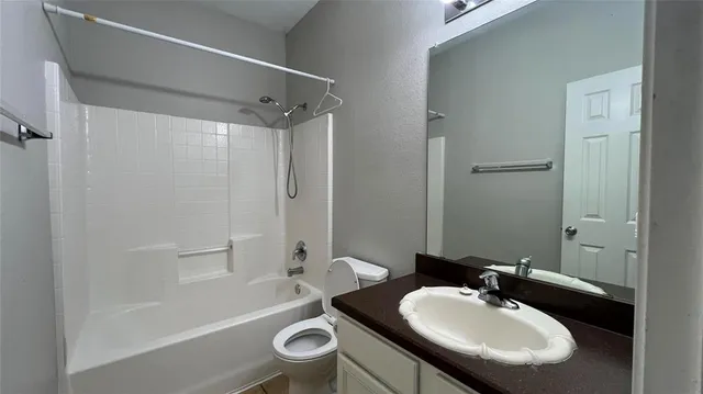 a bathroom with a sink toilet a mirror and shower