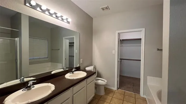 a bathroom with a sink double vanity and a mirror
