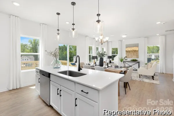 a very nice looking dining room with a large dining table and chairs