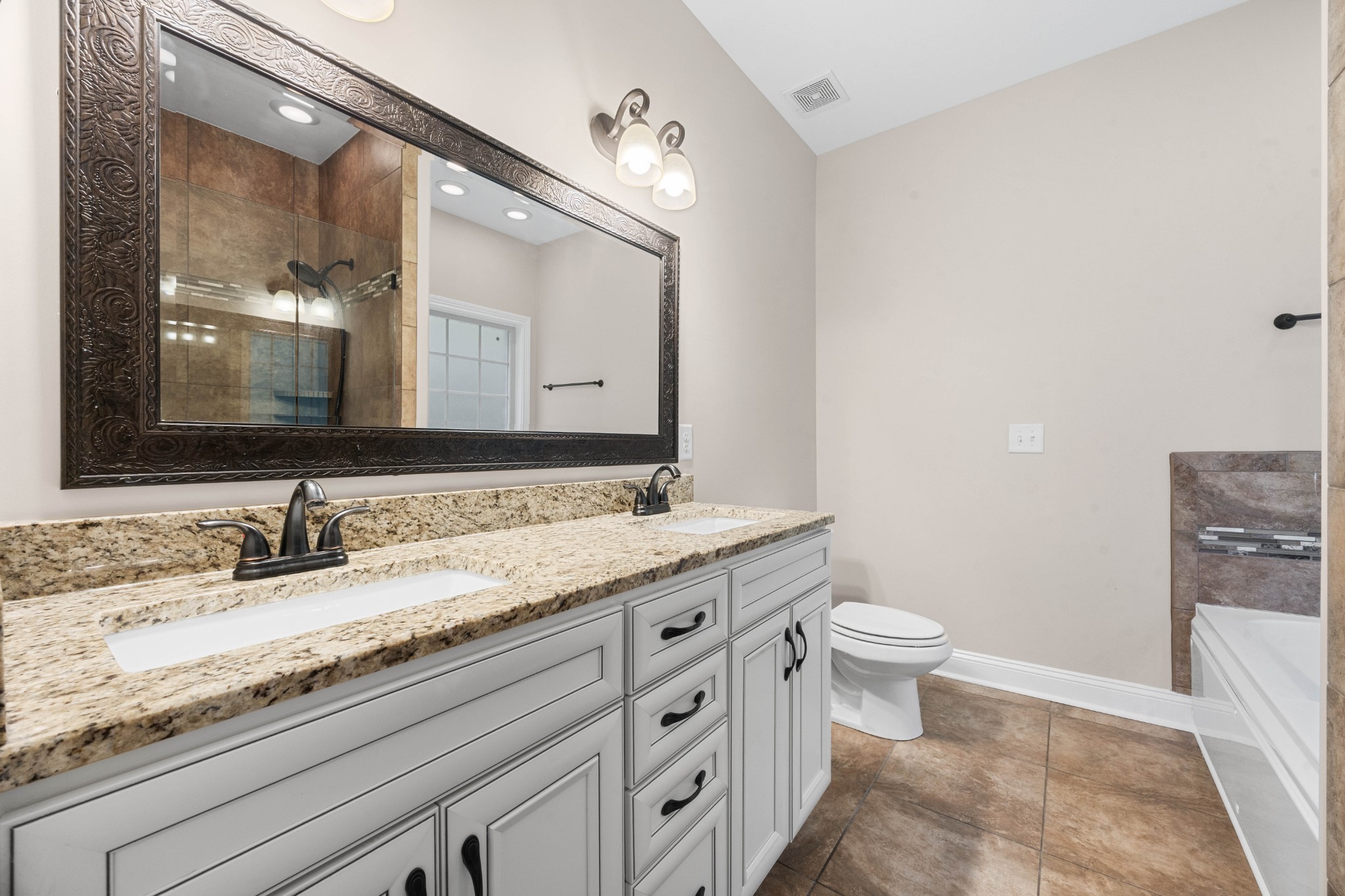 1789 Double R Boulevard Clarksville, TN 37042 - Photo 13 of 53 a bathroom with a granite countertop toilet sink and mirror