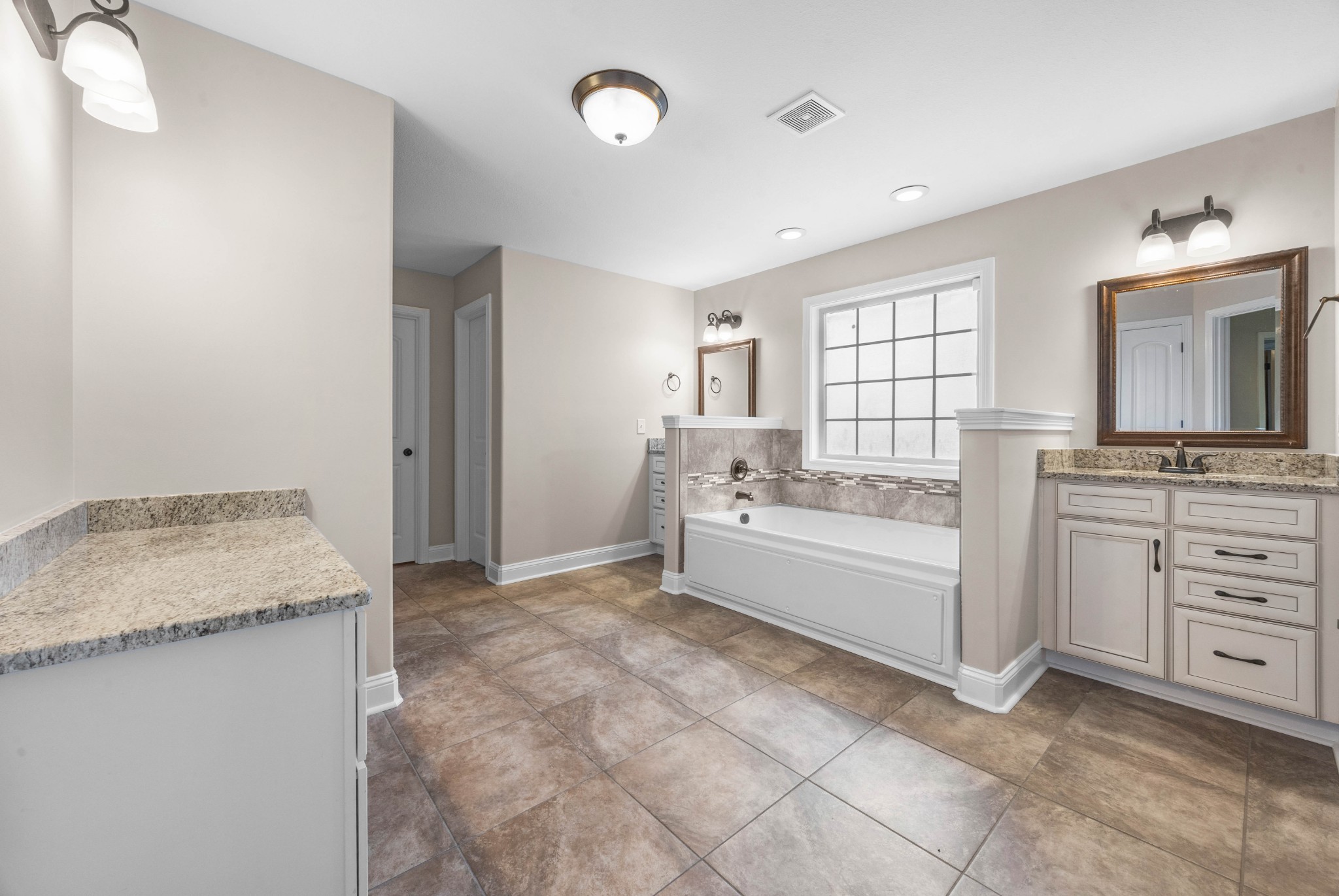1789 Double R Boulevard Clarksville, TN 37042 - Photo 34 of 53 a bathroom with a granite countertop sink mirror and a bathtub