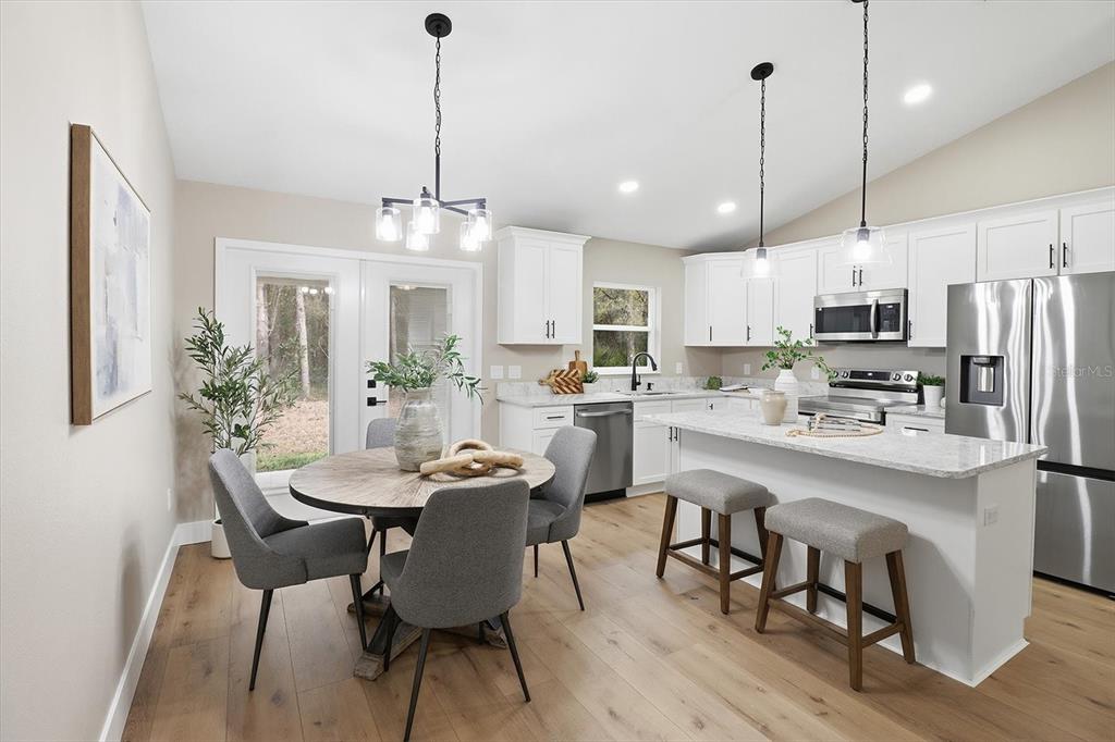 3671 East Ryan Street Inverness, FL 34453 - Photo 11 of 48 a kitchen with kitchen island a dining table and chairs