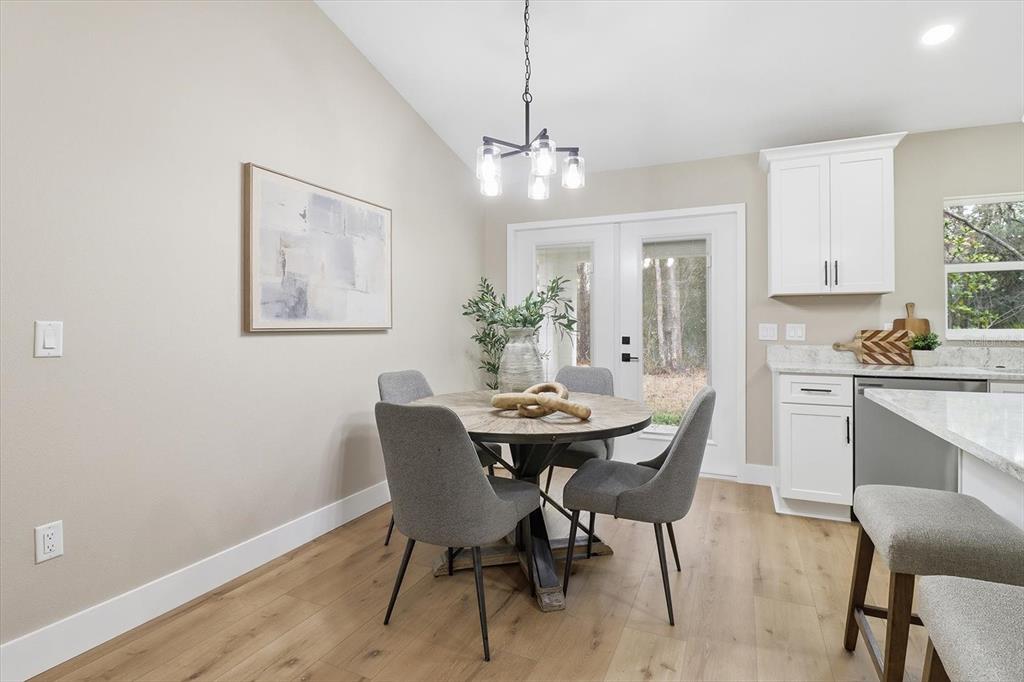3671 East Ryan Street Inverness, FL 34453 - Photo 12 of 48 a view of a dining room with furniture and wooden floor