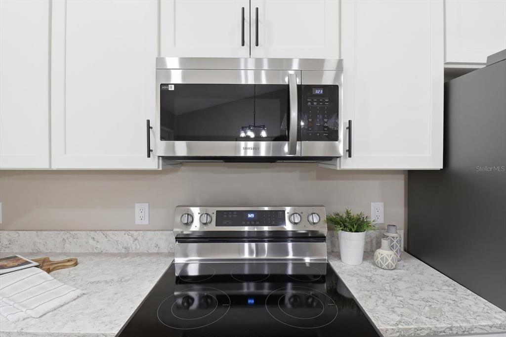 3671 East Ryan Street Inverness, FL 34453 - Photo 17 of 48 a kitchen with a stove and cabinets