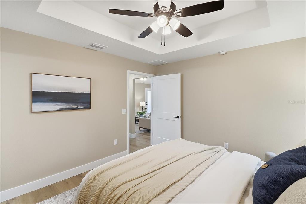 3671 East Ryan Street Inverness, FL 34453 - Photo 21 of 48 a bedroom with a bed and a chandelier