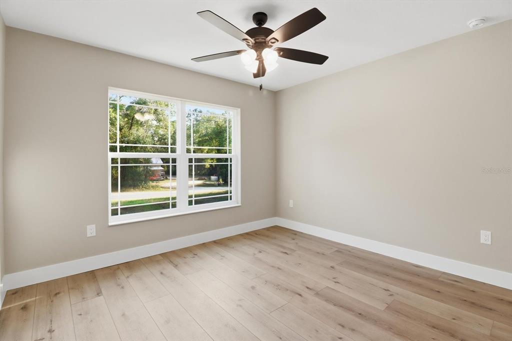3671 East Ryan Street Inverness, FL 34453 - Photo 26 of 48 a view of wooden floor and a chandelier fan in a room
