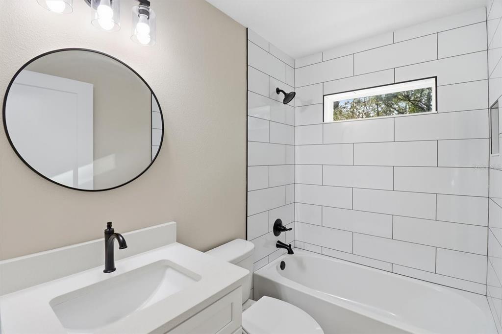 3671 East Ryan Street Inverness, FL 34453 - Photo 28 of 48 a bathroom with a sink and a mirror