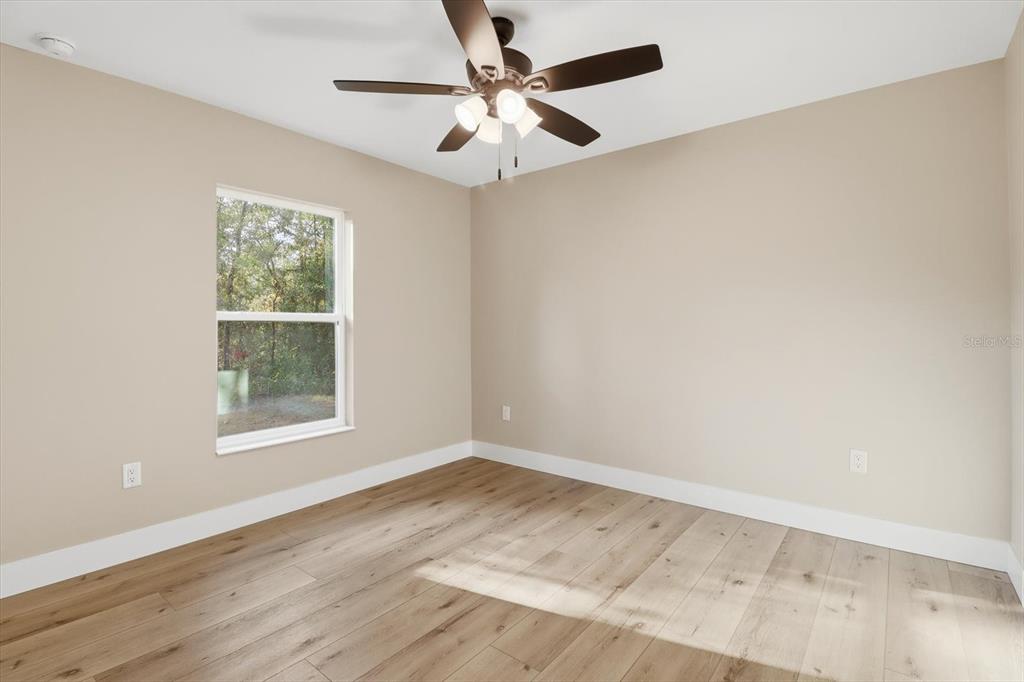 3671 East Ryan Street Inverness, FL 34453 - Photo 30 of 48 an empty room with a window and a ceiling fan