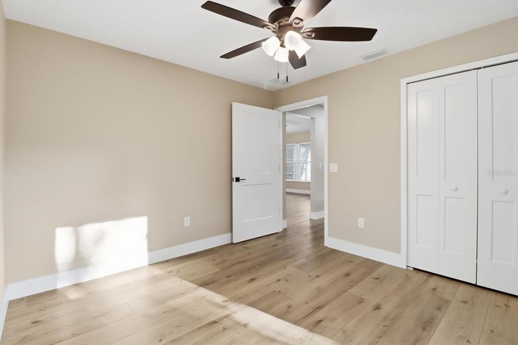 3671 East Ryan Street Inverness, FL 34453 - Photo 31 of 48 an empty room with wooden floor closet and ceiling fan