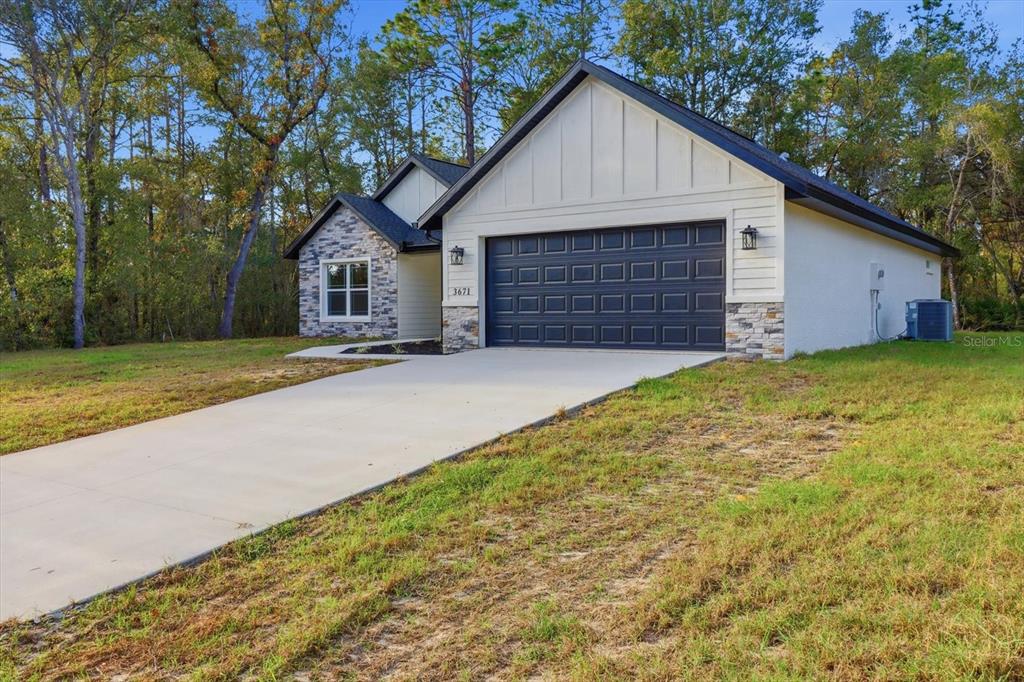 3671 East Ryan Street Inverness, FL 34453 - Photo 47 of 48 a view of a house with a yard and garage