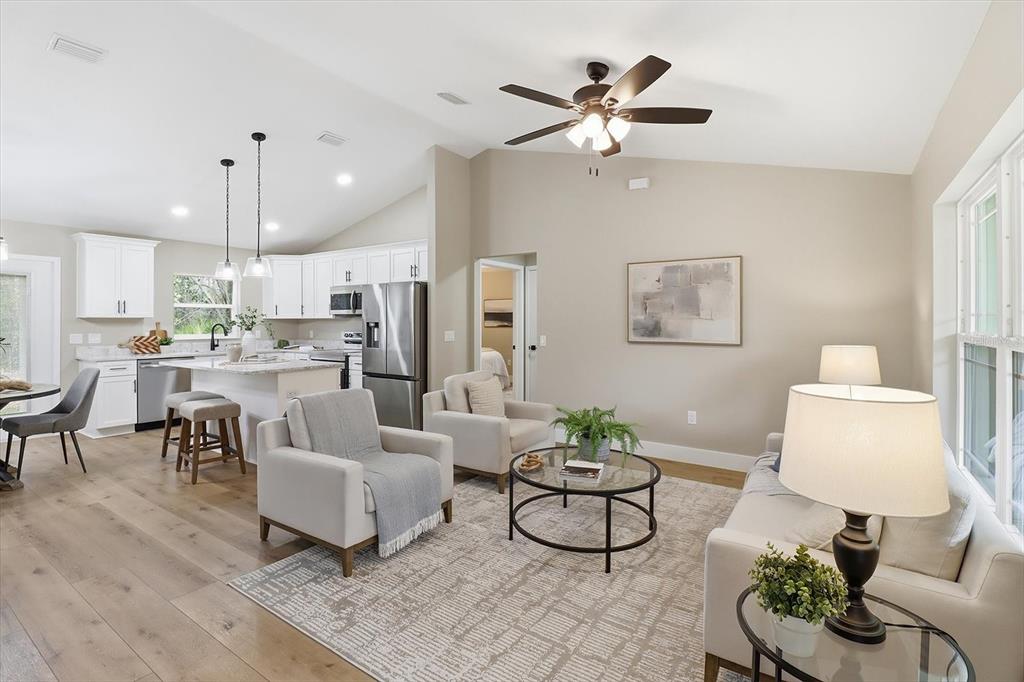 3671 East Ryan Street Inverness, FL 34453 - Photo 6 of 48 a living room with furniture kitchen view and a chandelier