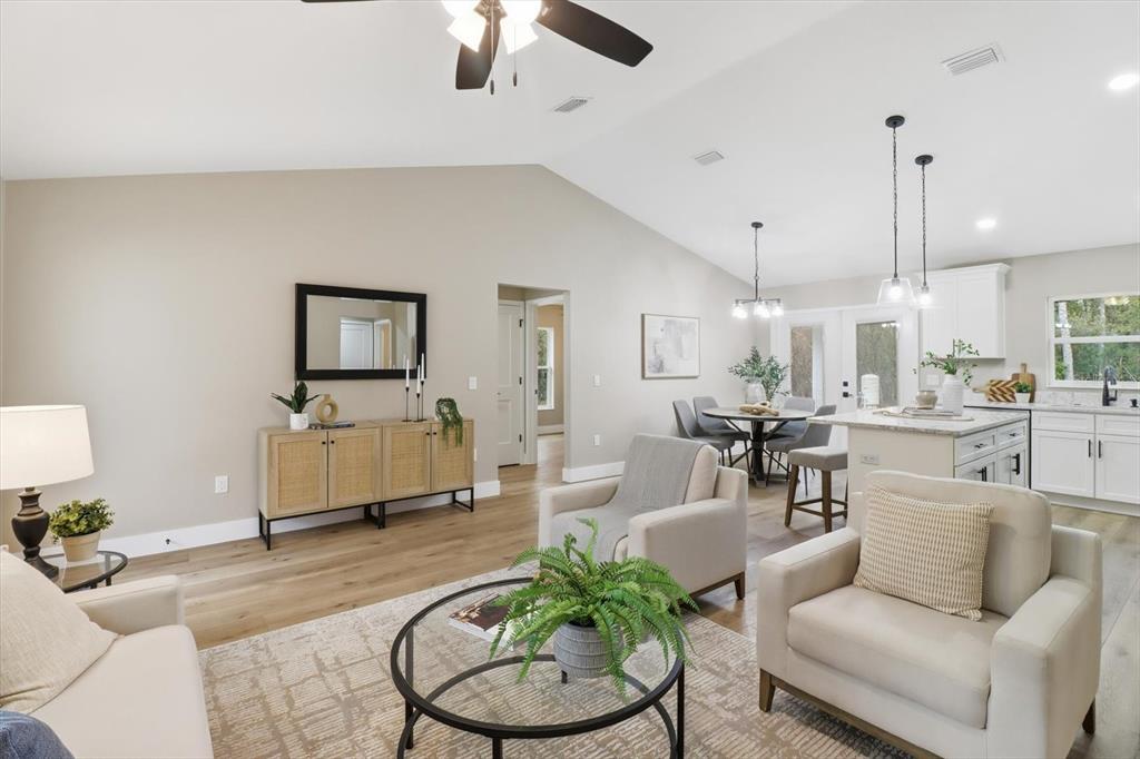 3671 East Ryan Street Inverness, FL 34453 - Photo 8 of 48 a living room with furniture and a chandelier