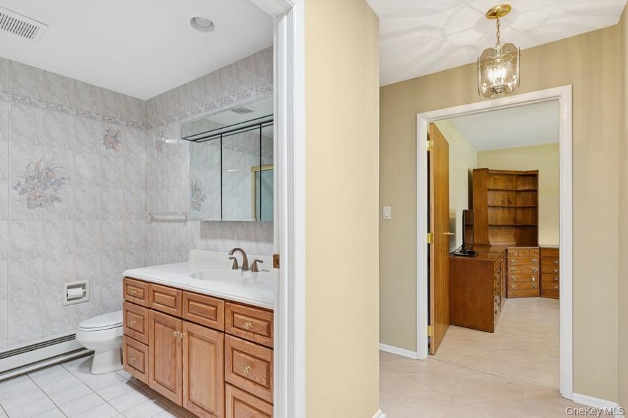96 Enfield Court, Unit B Ridge, NY 11961 - Photo 13 of 22 a bathroom with a sink double vanity and a toilet