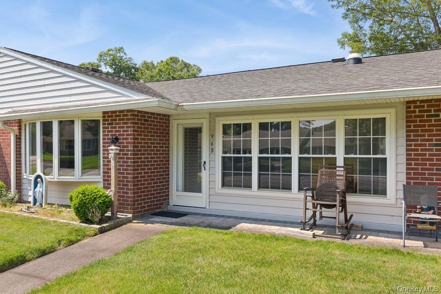 96 Enfield Court, Unit B Ridge, NY 11961 - Photo 20 of 22 a house view with a garden space